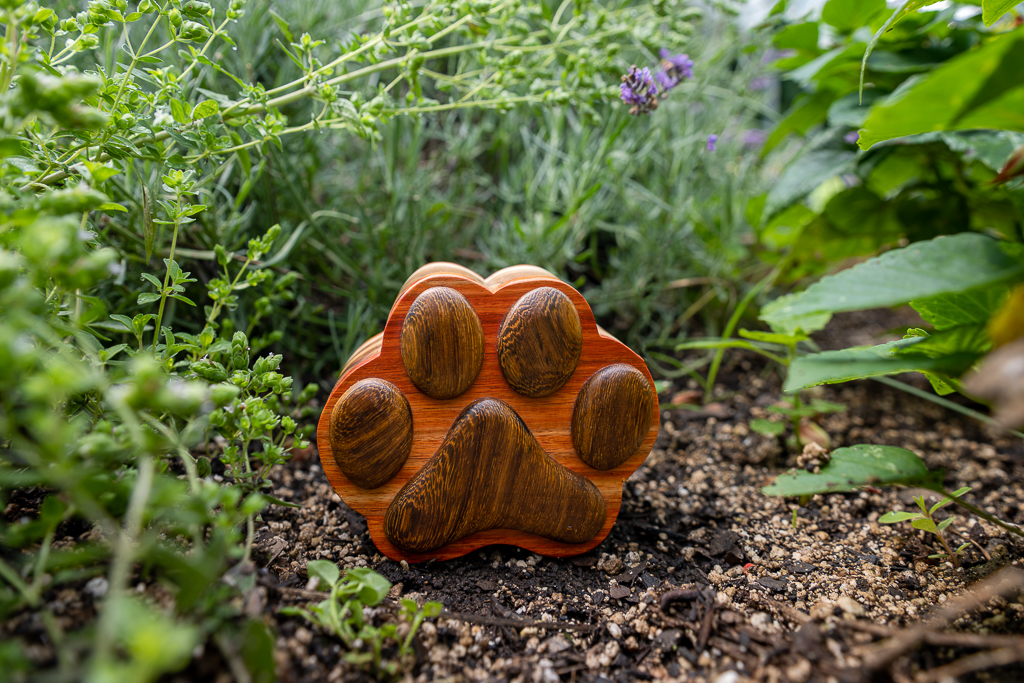 Brass Paw Print Jar. Rounded brass pot-shaped urn with single paw print on lid. Top threaded lid to ensure secure closure. 3 sizes available.